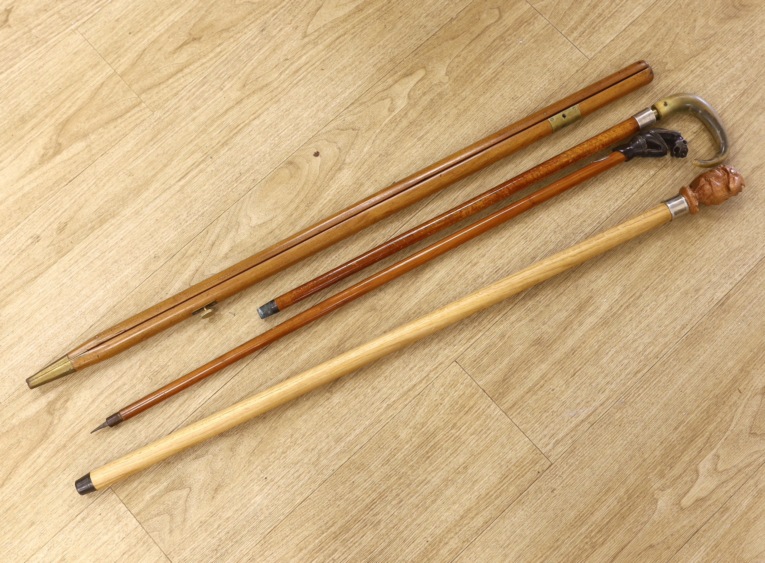 Four canes / walking sticks including a horse measuring stick and a military pace stick